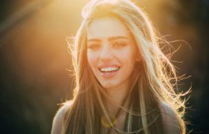 attractive blonde laughs in the sunshine